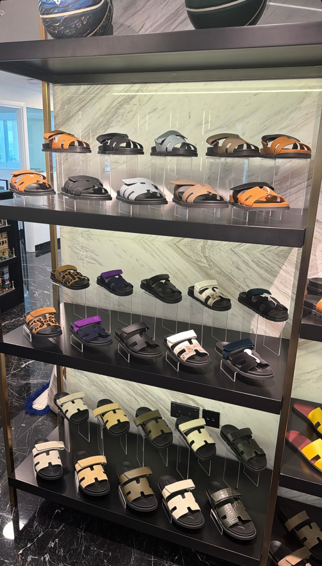 Luxury designer sandals displayed on the shelves of The Shoe Salon in Dubai